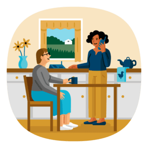 Illustration of an individual sitting at a kitchen table and a direct support professional standing at the kitchen counter using a landline telephone.