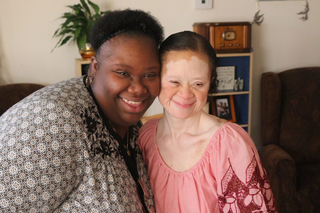 Image of two women smiling together.