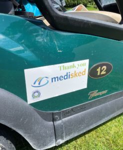 Golf cart with a sign on it that says "Thank You MediSked"